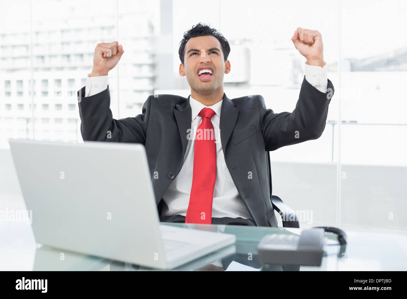Businessman cheering desk in office hi-res stock photography and images ...