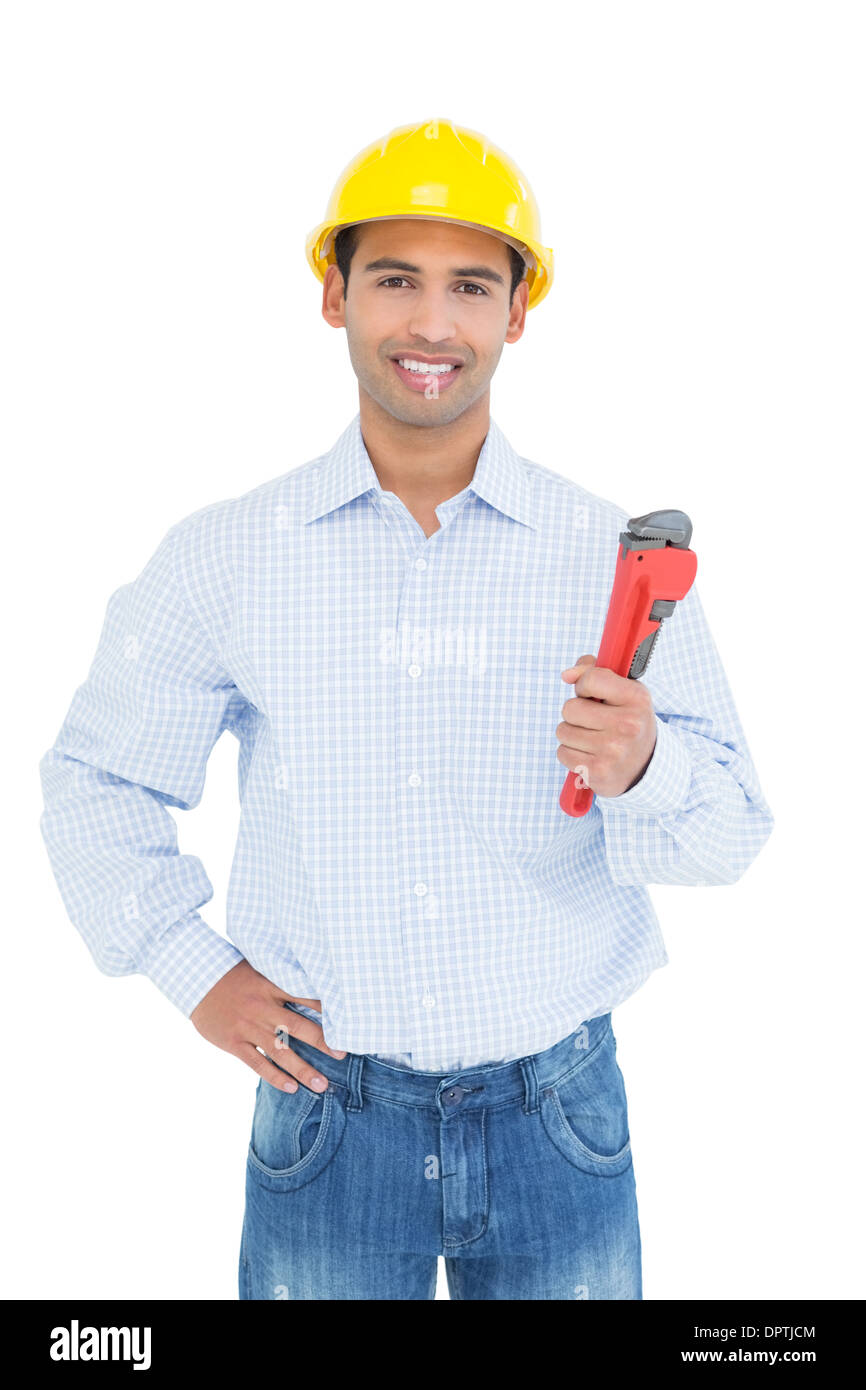 Handsome young handyman holding pipe wrench Stock Photo