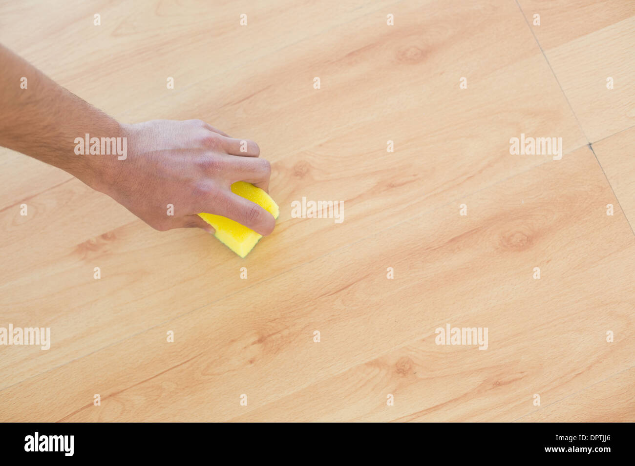 Hand with sponge cleaning the parquet floor at home Stock Photo Alamy