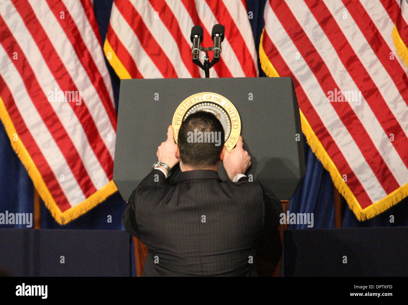 Feb 18, 2009 - Mesa, Arizona, USA - A White House aid places the Presidential seal on the podium before President Obama addresses the audience at Dobson High School. President Obama was in town because Arizona has the third highest foreclosure rate in America. .  (Credit Image: © Darryl Webb/East Valley Tribune/ZUMA Press) Stock Photo