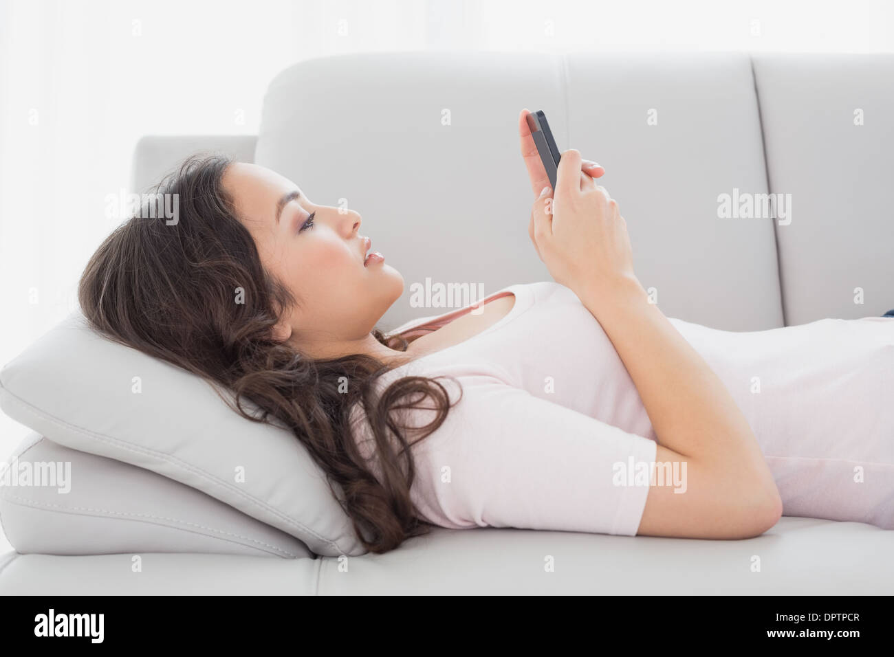 Relaxed young woman touching hair hi-res stock photography and images ...