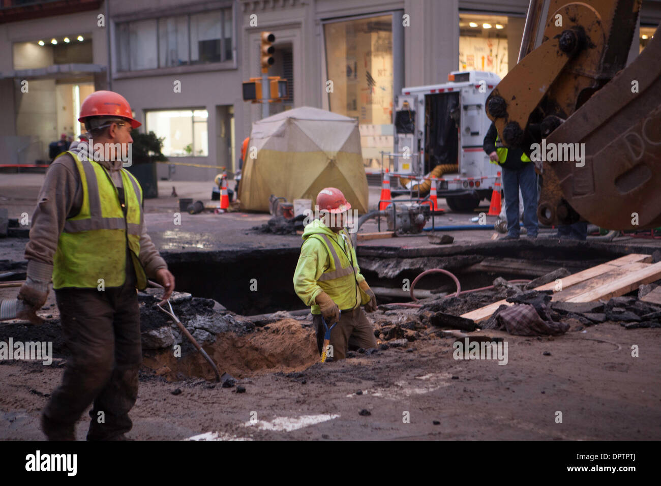 New York, USA. 15th January 2014. Crews from the DEP and ConEd continue to excavate to locate a water main break that flooded 5th Ave in Greenwich Village and left several nearby buildings without water.  Workers estimate it will take several days to locate and repair the break. Credit:  Mansura Khanam/Alamy Live News Stock Photo