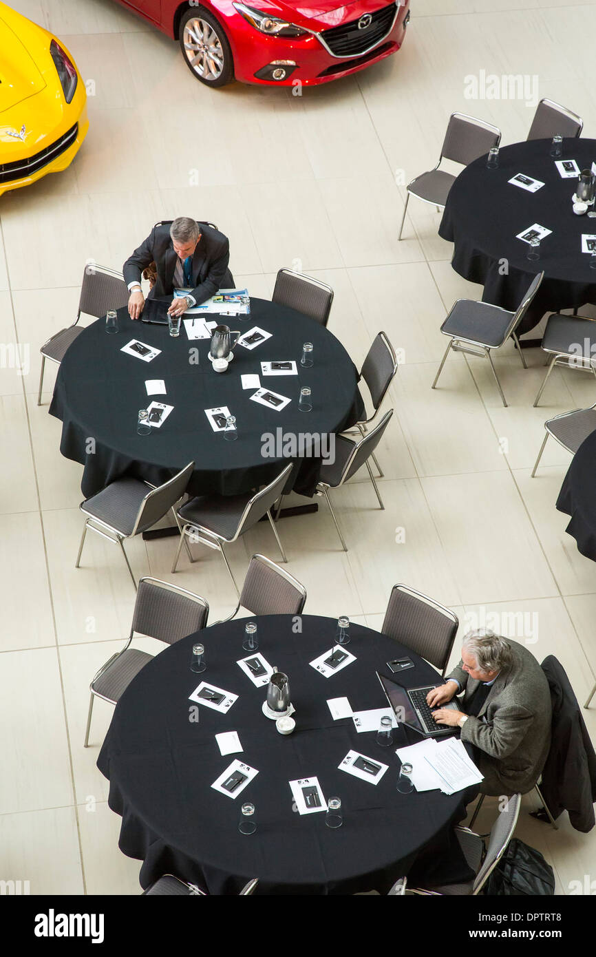 Auto industry professionals at work before a meeting of the Society of Automotive Analysts. Stock Photo