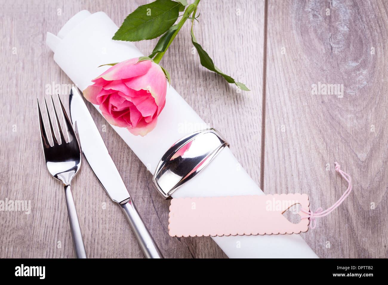 Romantic formal elegant table setting with a single pink rose and ...