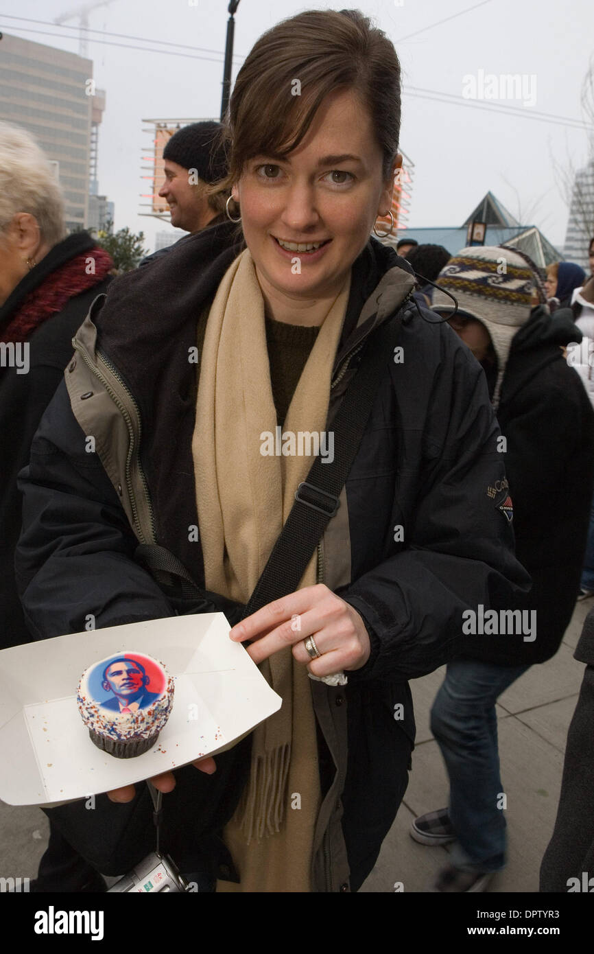 Jan 20, 2009 - Seattle, Washington, USA - LEIGH BEACH from Seattle holds a cupcake with Barack Obama on it, 'this is an amazing day,' she said 'I am very proud of us as a nation.' From cup cakes to Jones Soda Cola, everyone is cashing in on Obama's image. Over 2500 people turned out to watch a large TV screen at the Paramount theatre in Seattle,WA. It was standing room only in the  Stock Photo