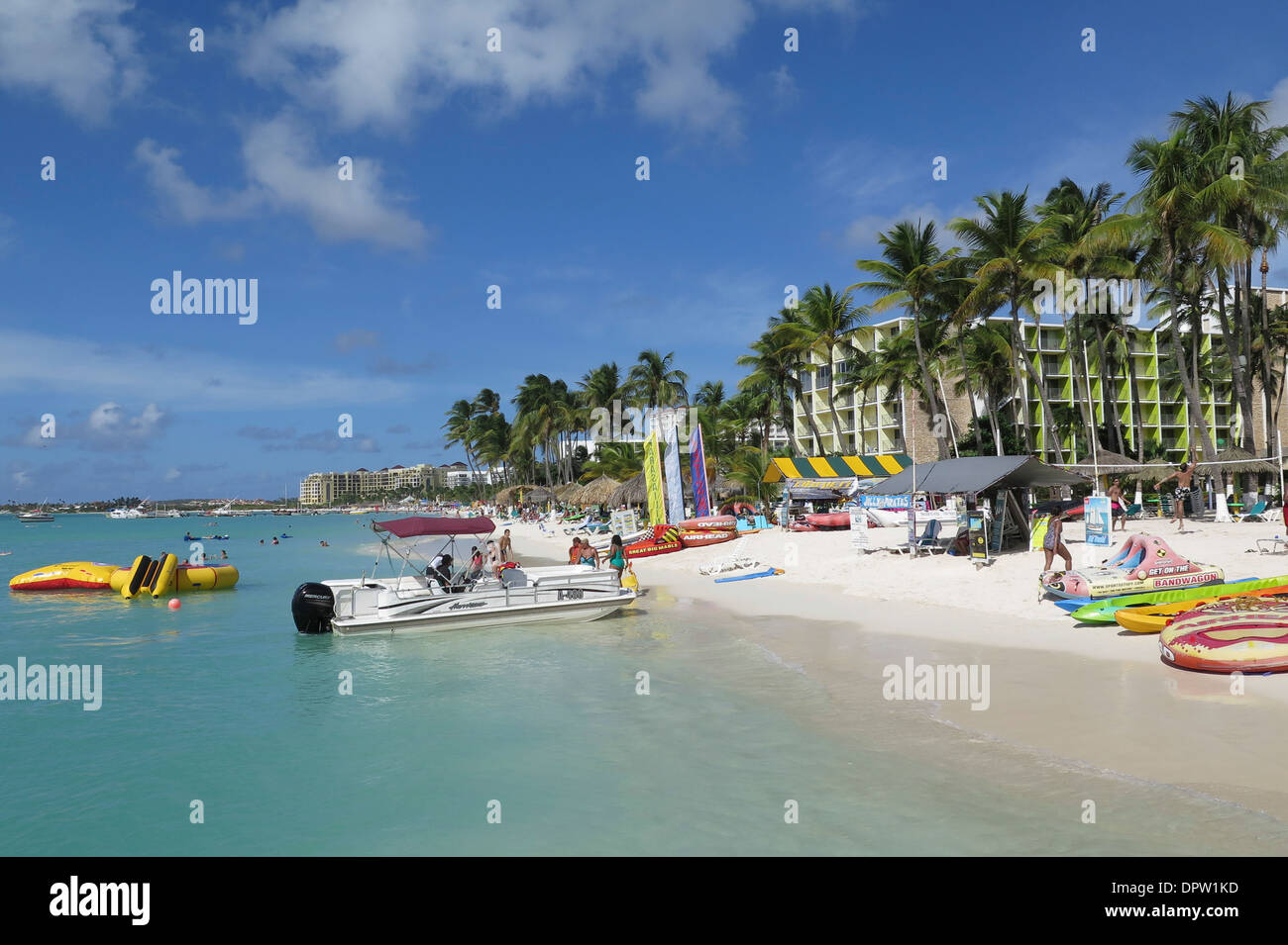 Holidaymakers enjoying water sports on Aruba's Palm Beach Stock Photo