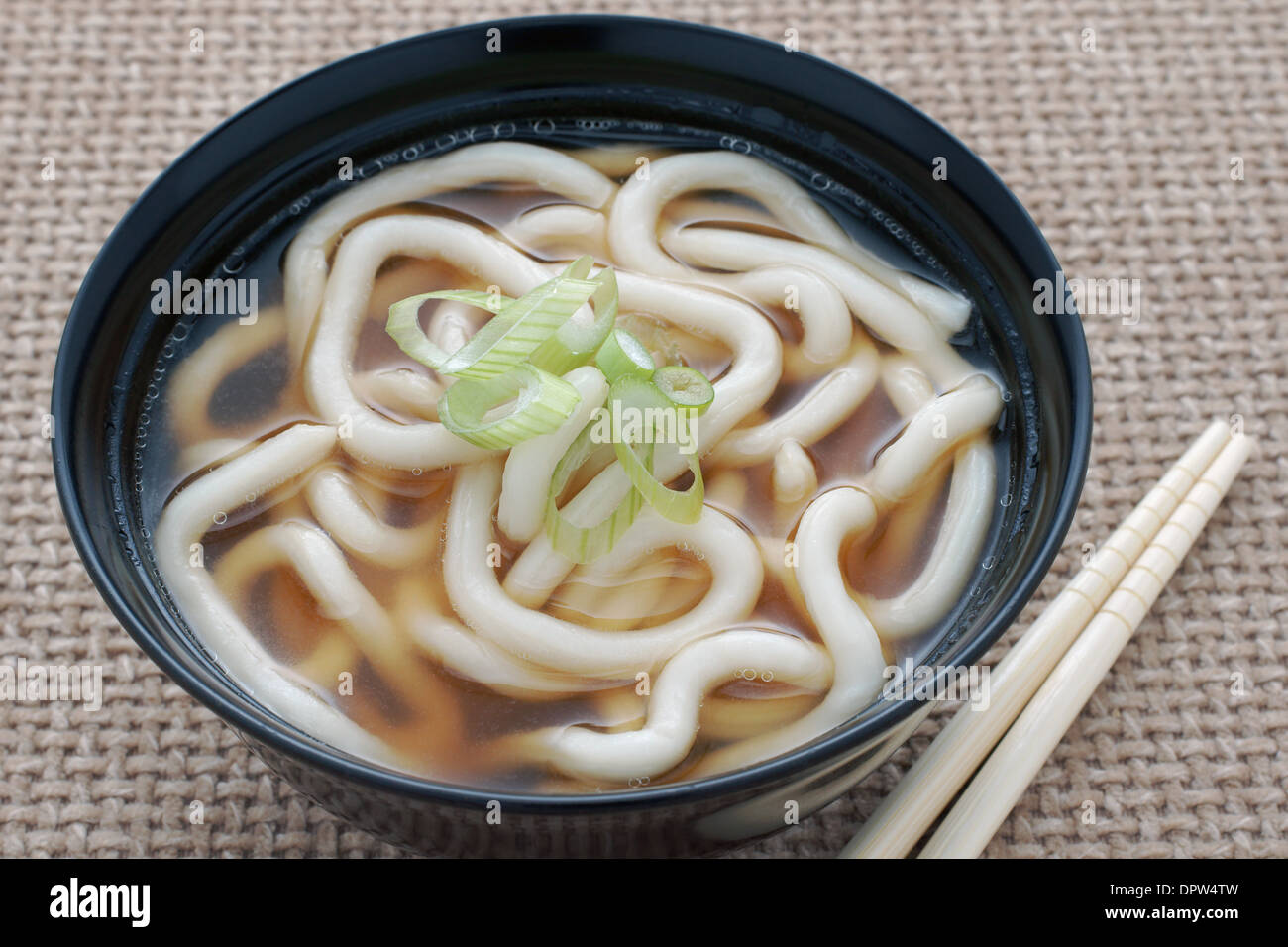 Udon Noodles in a soup base with scallions known as Kake udon or Su udon in Japanese cuisine Stock Photo