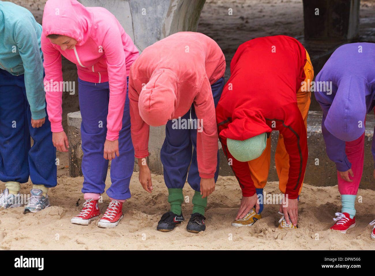 Bodies in Urban Spaces performers in colourful hoodies give a bow at the end of their performance at Bournemouth, Dorset UK  in June Stock Photo