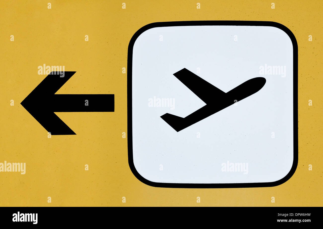 Sign with an airplane taking off for the direction of the departure terminal at an airport Stock Photo