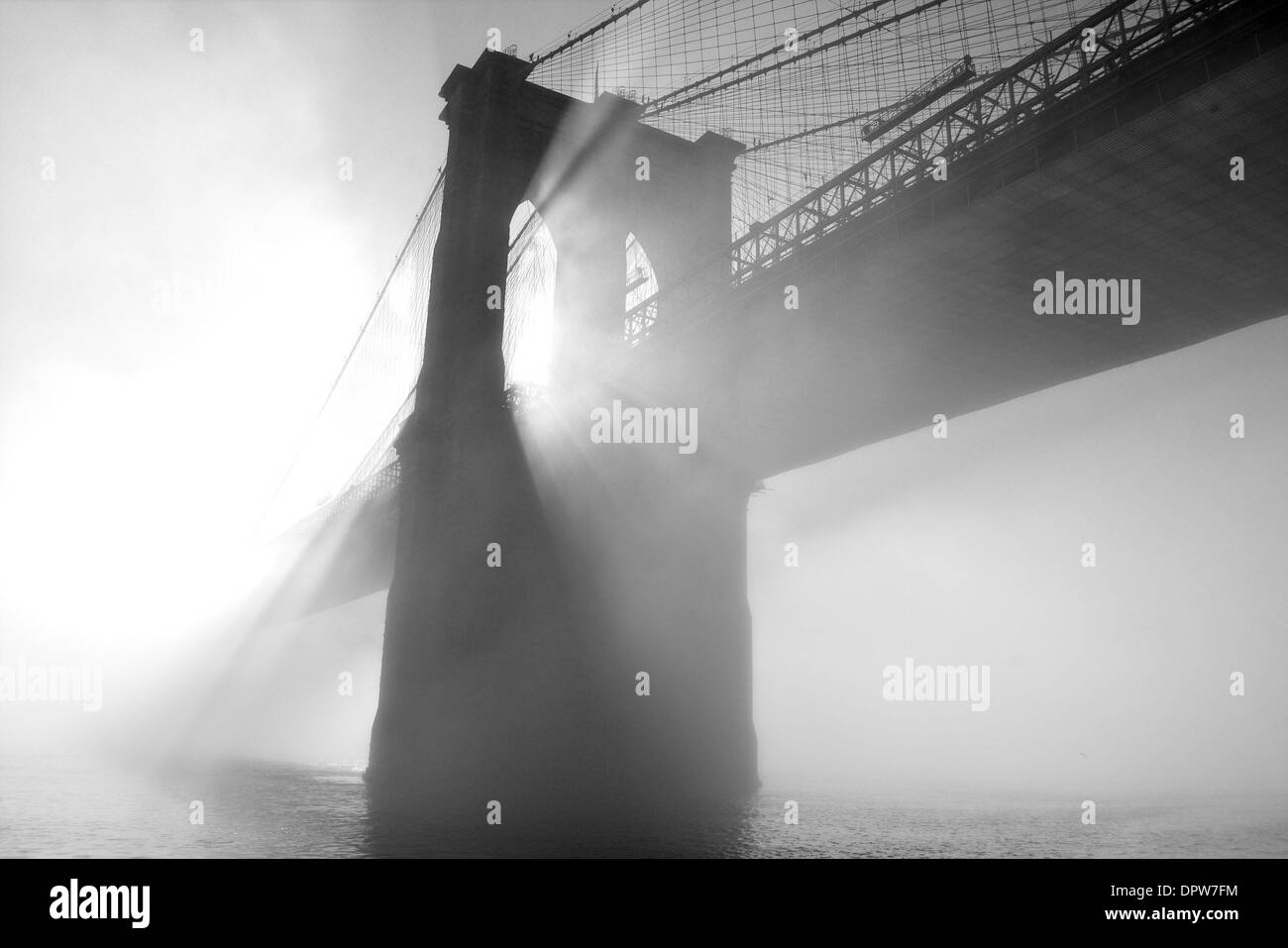 Brooklyn Bridge covered in fog. Stock Photo