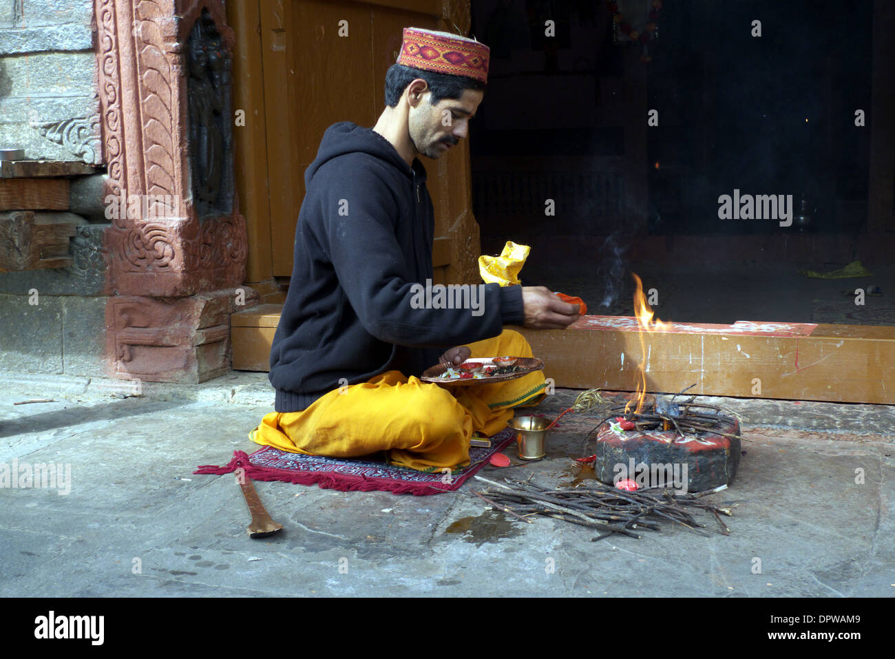 Brahmin priest making offerings at Krishna/Murlidha temple, Naggar, Kullu Valley, Himachal Pradesh, North India. Stock Photo