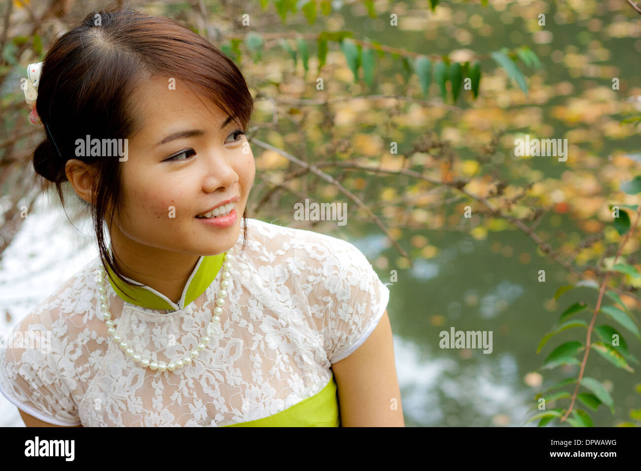 Young Vietnamese Woman Smiling to the Side Stock Photo