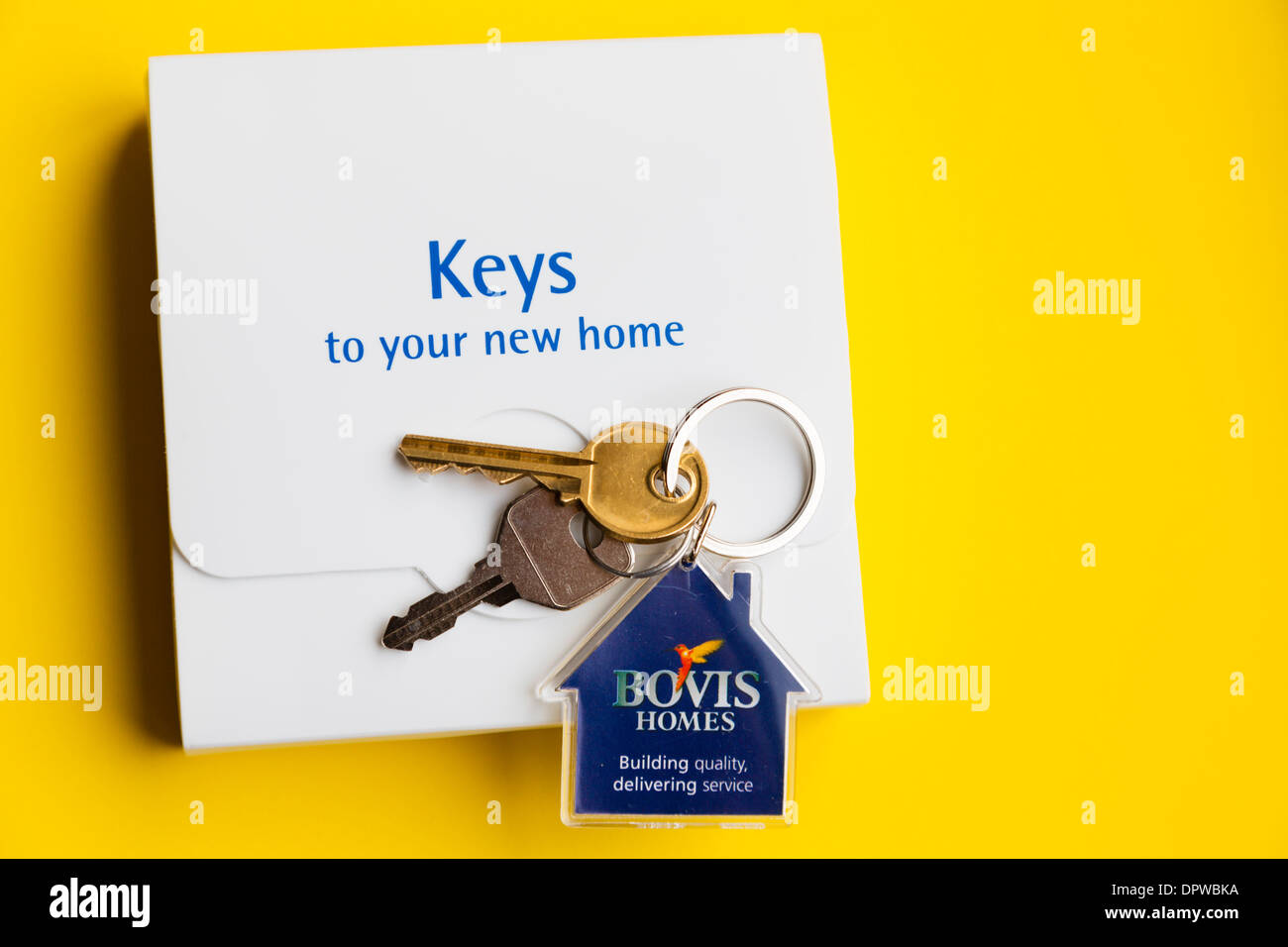 New house keys with box, Bovis Homes, on yellow background Stock Photo