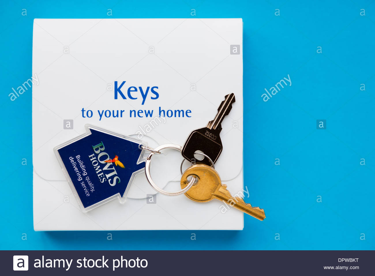 New house keys with box, Bovis Homes, on blue background Stock Photo