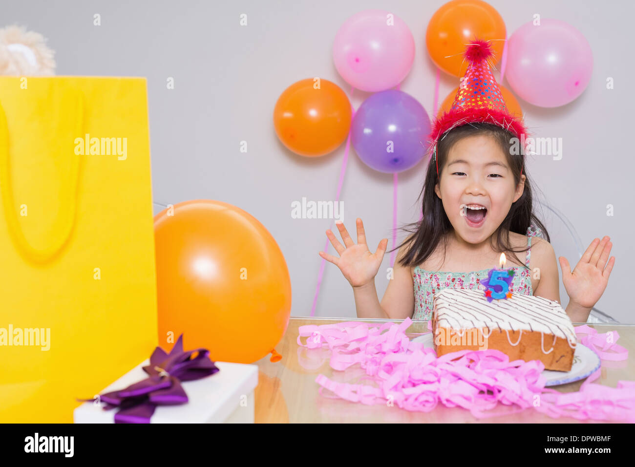 Cheerful little girl at her birthday party Stock Photo