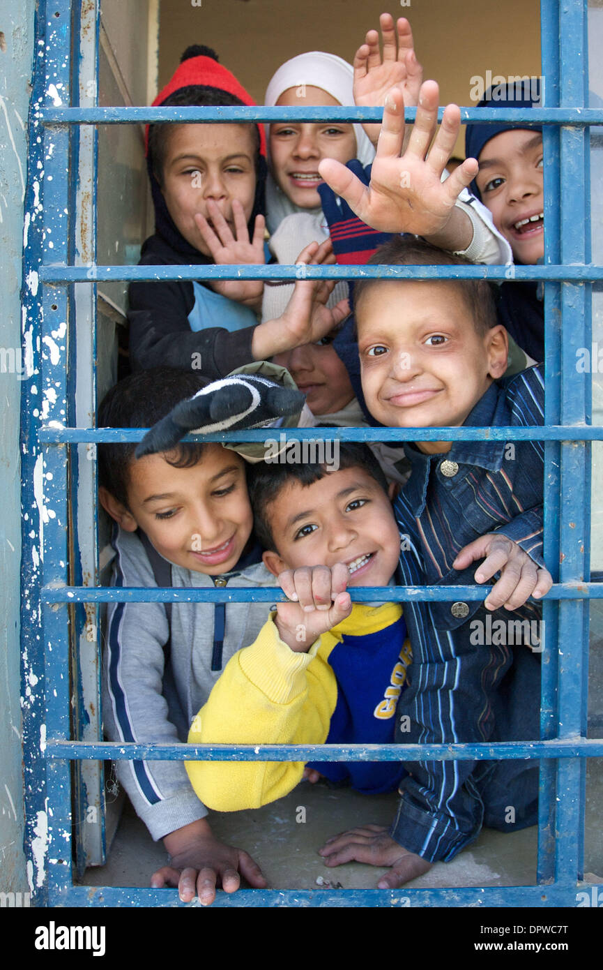 Dec 31, 2008 - Baghdad, Iraq - Iraqi children wave from the window of a school being refurbished by U.S. Army Civil Affairs in Abu Ghraib. (Credit Image: © John Goodman/ZUMA Press) Stock Photo