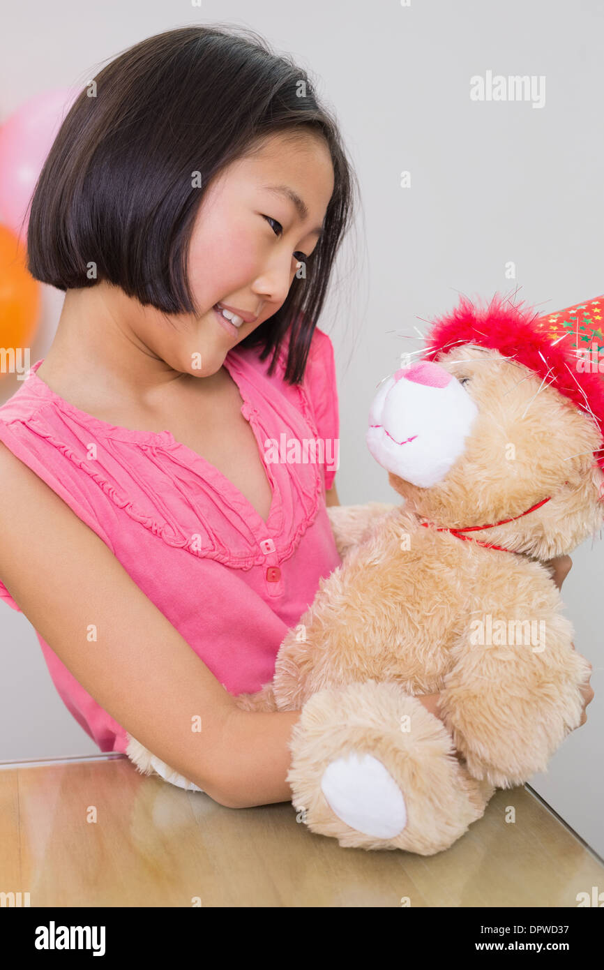 Cute girl with her soft toy at a birthday party Stock Photo - Alamy