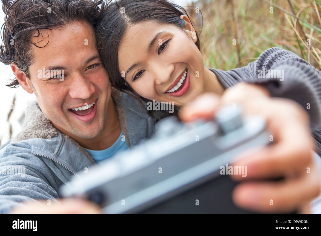 Take voice. Chinese man and woman. People taking a photo with Samsung a 52.