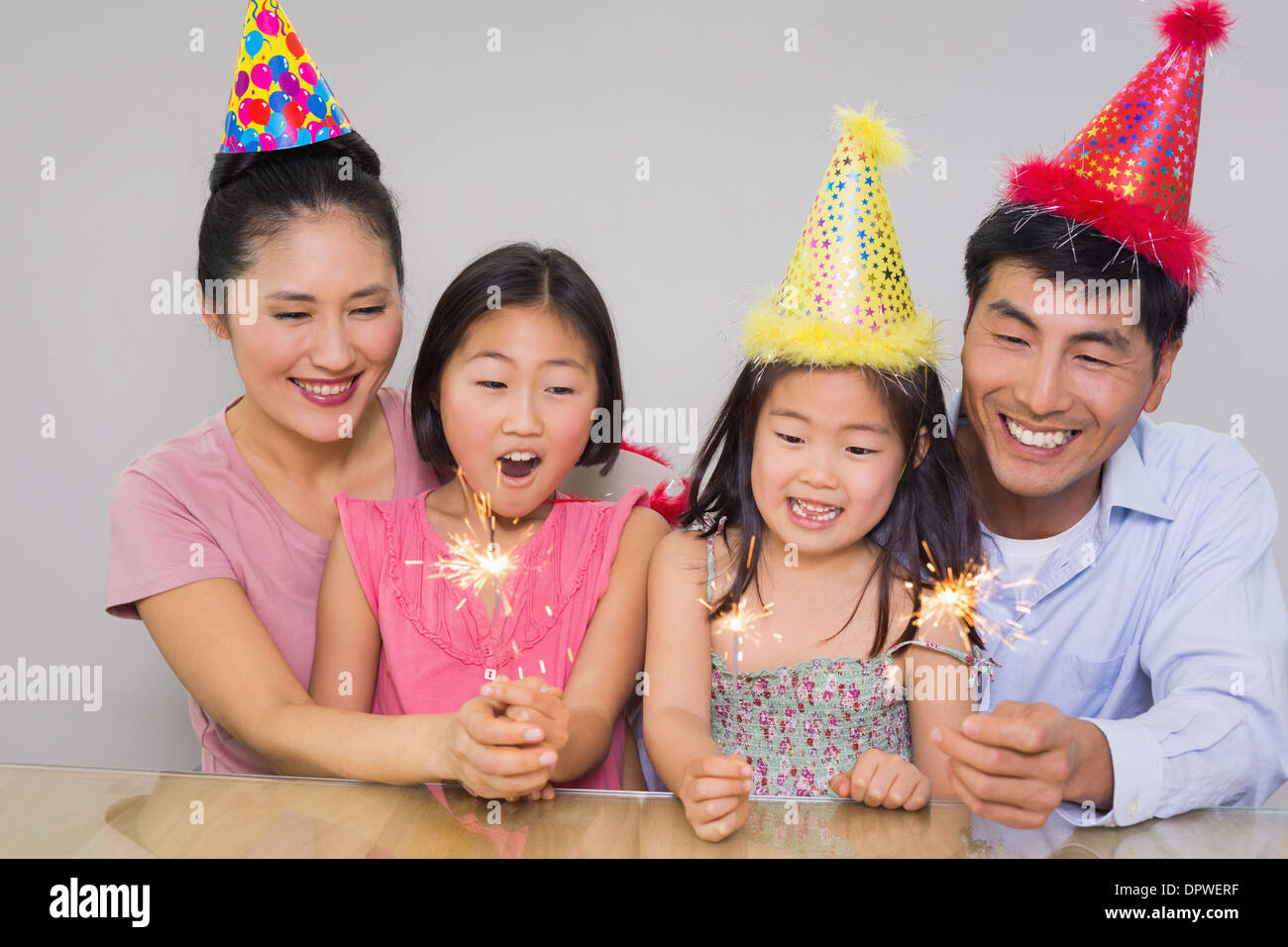 Cheerful family of four playing with firecrackers Stock Photo