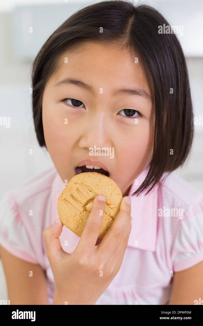 Closeup portrait of a young girl eating cookie Stock Photo Alamy