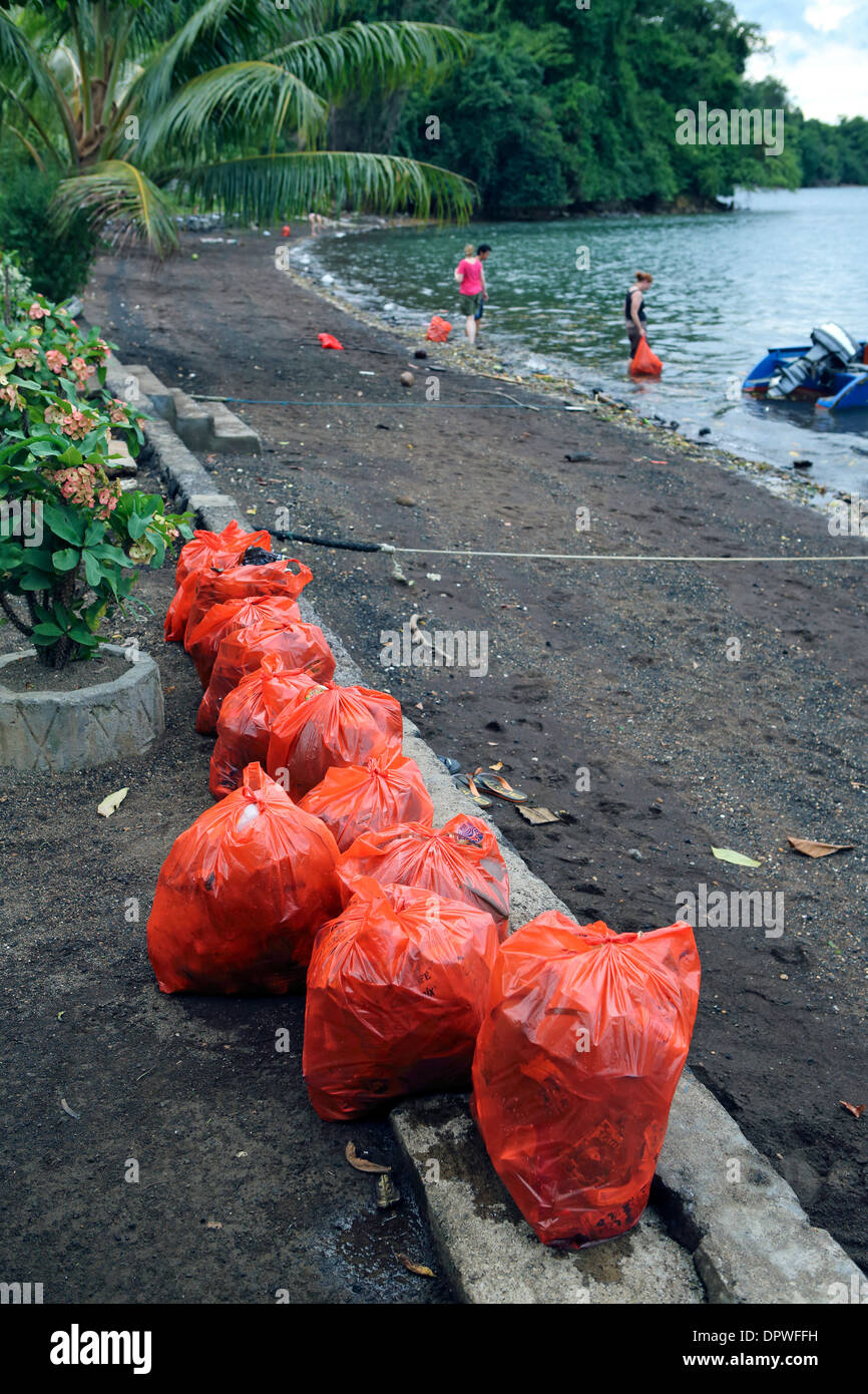 Plastic bags full of garbage that washed up with the tide on beach at
