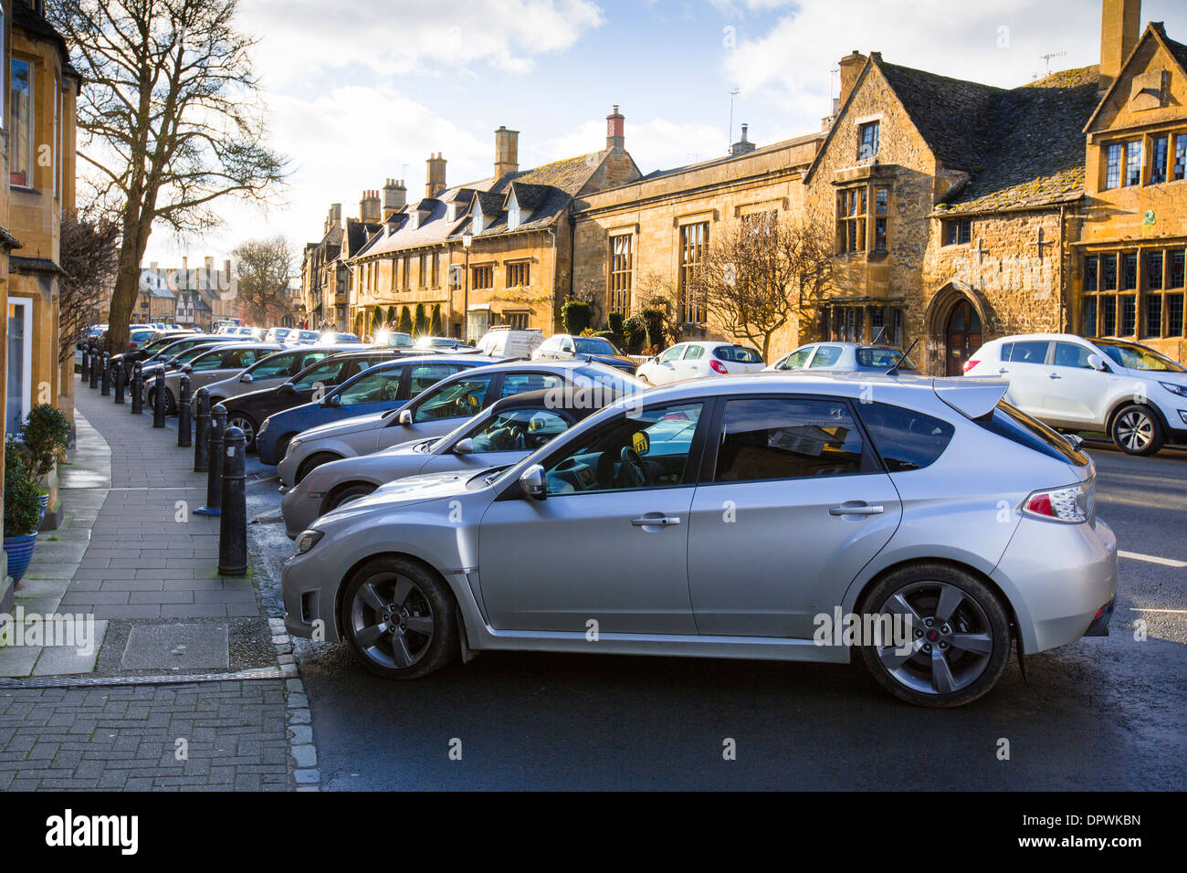 Vehicles parked in the High Street in Chipping Campden, Gloucestershire. Stock Photo