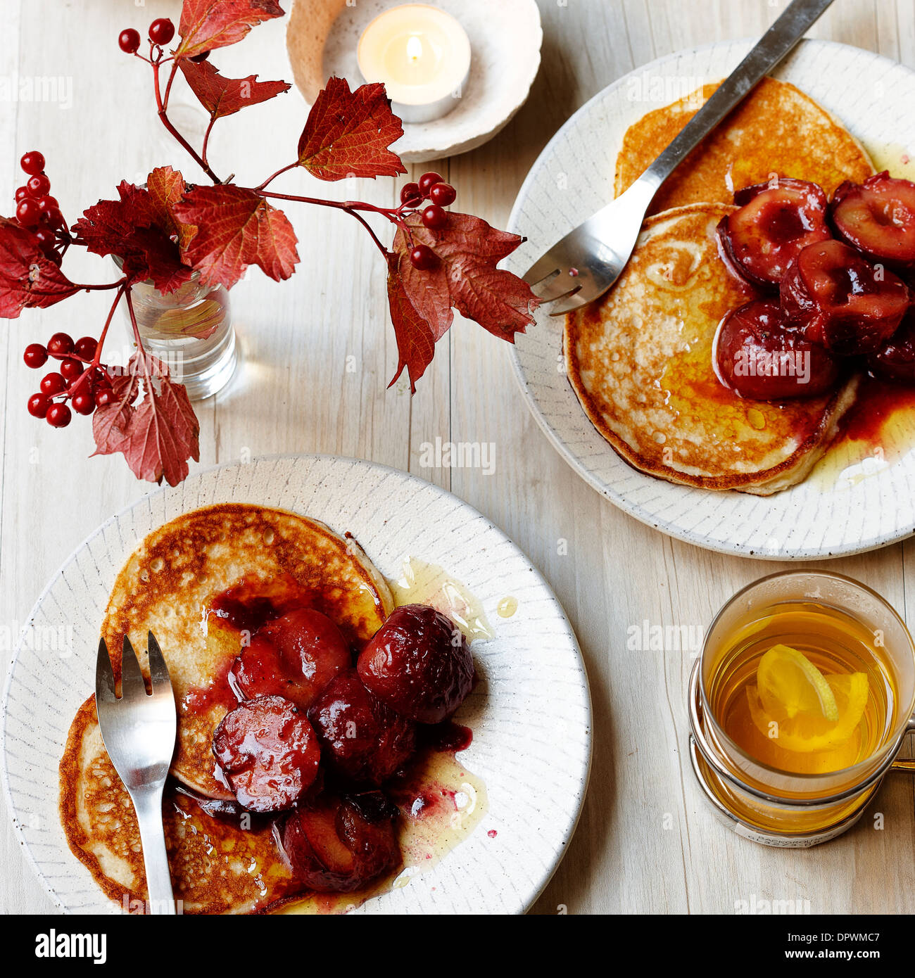 Spelt cake pancakes with stewed plums Stock Photo