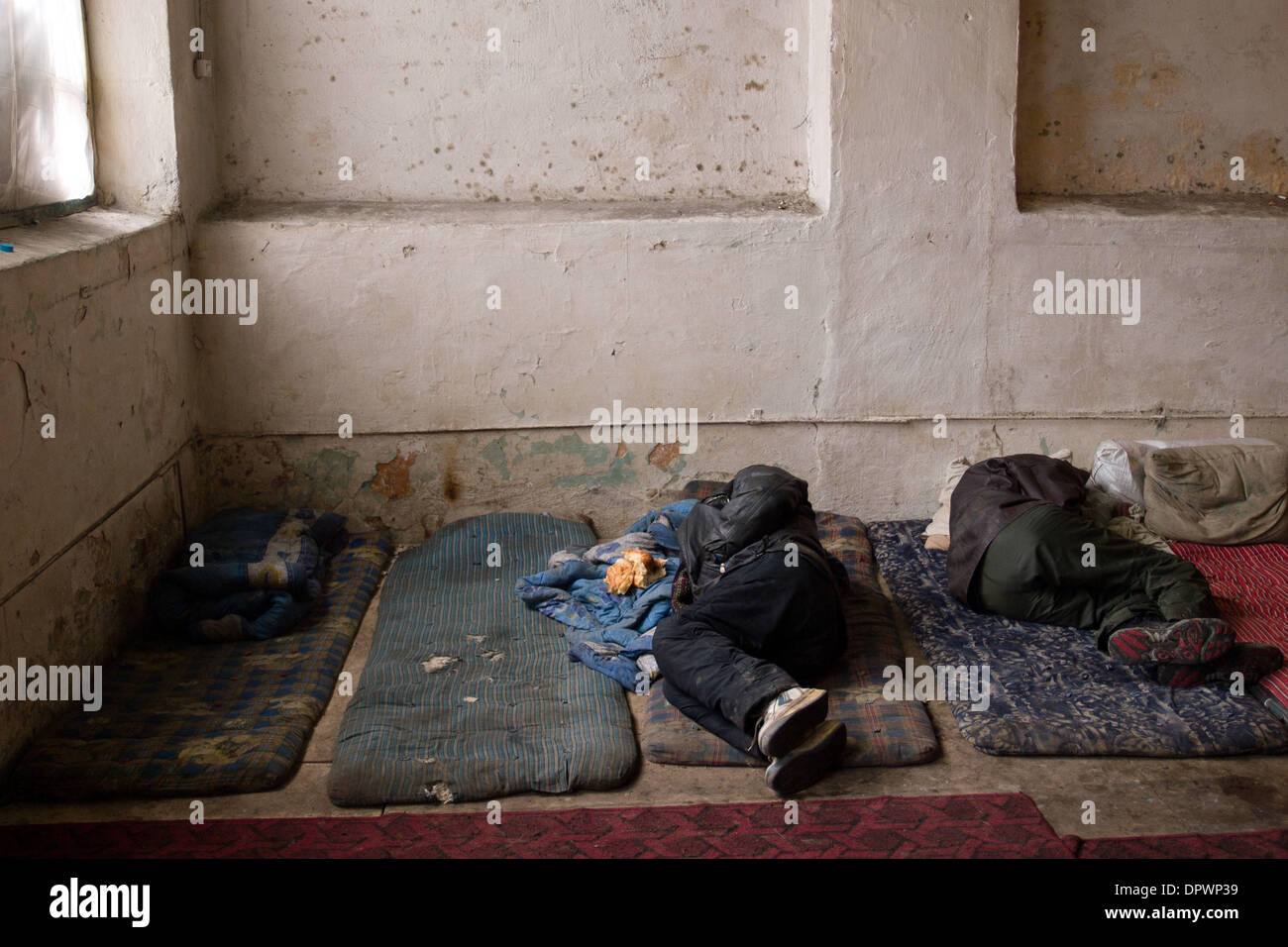 Feb 12, 2009 - Bishkek, Kyrgyzstan - A homeless man sleeps in the only shelter provided by the government for the homeless. After being cited by the UN for not helping the homeless, the Kyrgyz government responds by opening an abandoned building without a bathroom or even running water. The facility provides nothing except protection from the cold. (Credit Image: © George Hsia/ZUMA Stock Photo