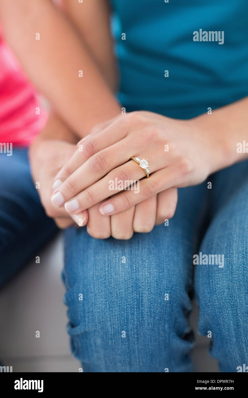 Closeup mid section of female friends holding hands Stock Photo Alamy
