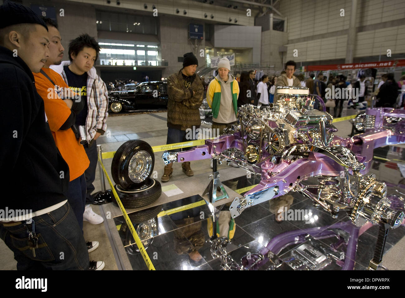 Nov 25, 2008 - Chiba, Japan - Customized classic cars showcasing the American lowrider culture are displayed at the Lowrider Japan Car Show which took place at Makuhari Messe Convention Center in Chiba, Japan. Pictured: Japanese fans look at a customized engine and car chassis. (Credit Image: © Christopher Jue/ZUMA Press) Stock Photo