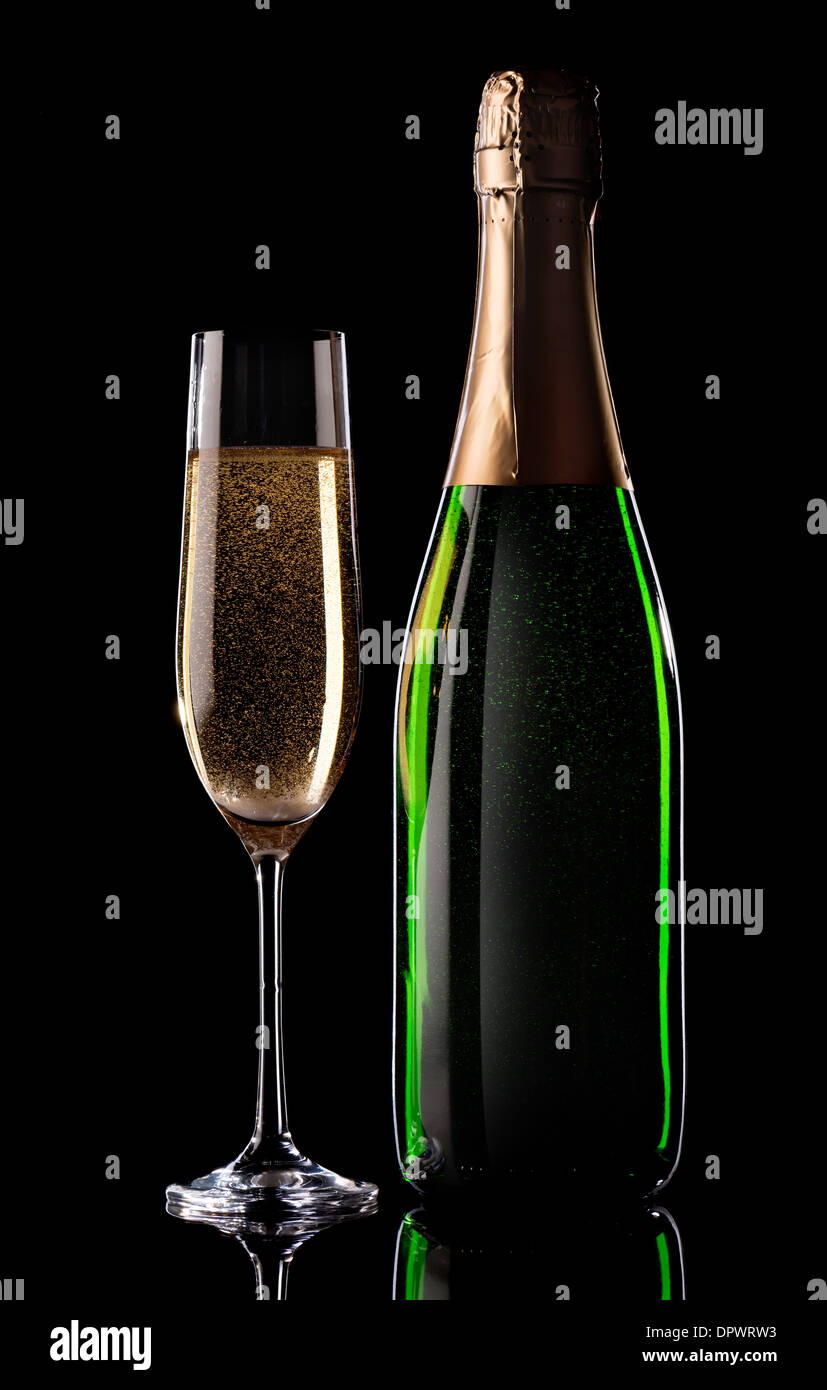 Glass and bottle of champagne on black background Stock Photo