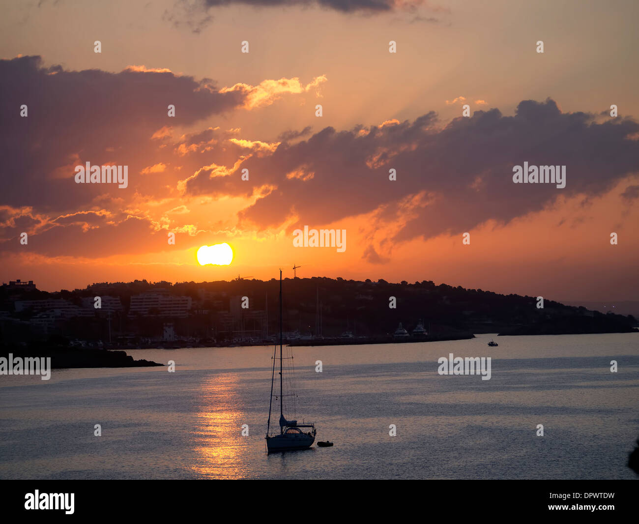 Silhouette of a yacht  as the sun rises over the bay of Palma Nova Majorca Spain Stock Photo