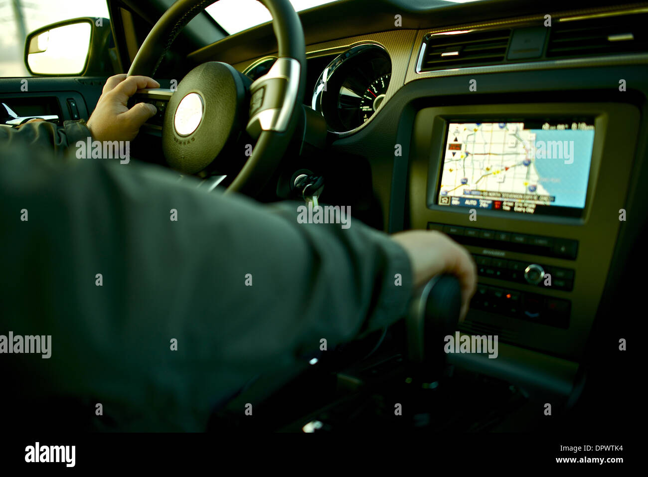 Car Navigation - Driving a Car with Navigation and Multimedia System. Car Interior with Male Driver. Transportation Photo Collec Stock Photo