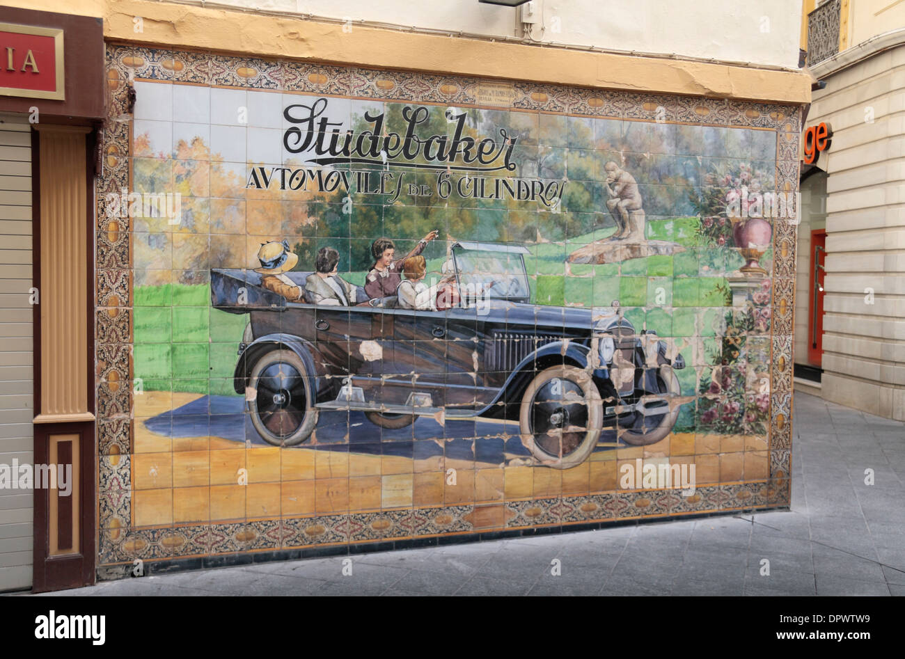 Beautiful tiled street artwork showing the Studebaker, a 6 cylinder car, in Seville (Sevilla), Andalusia, Spain. Stock Photo