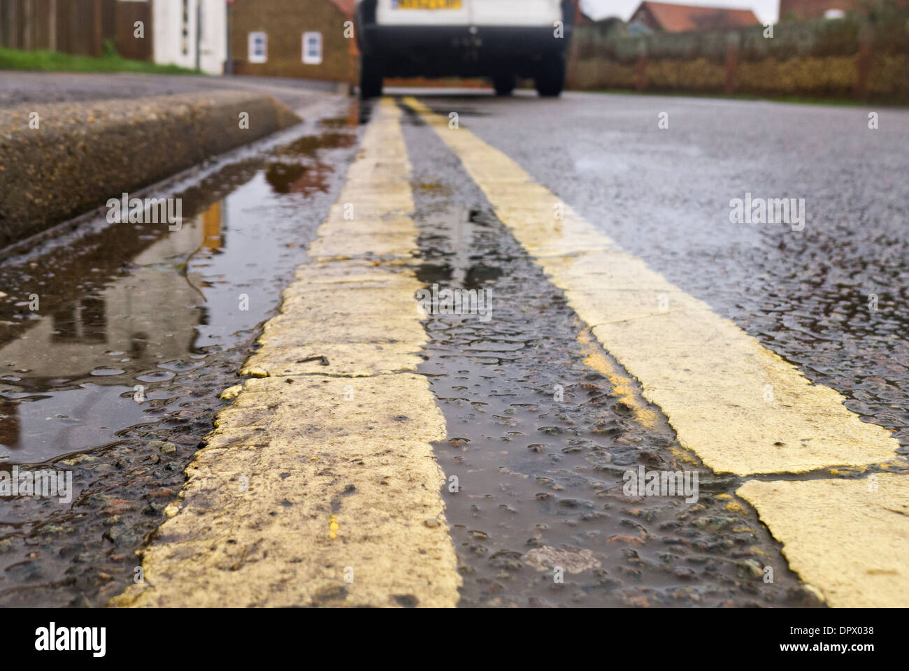 Double yellow lines and a white van parked illegally. Stock Photo
