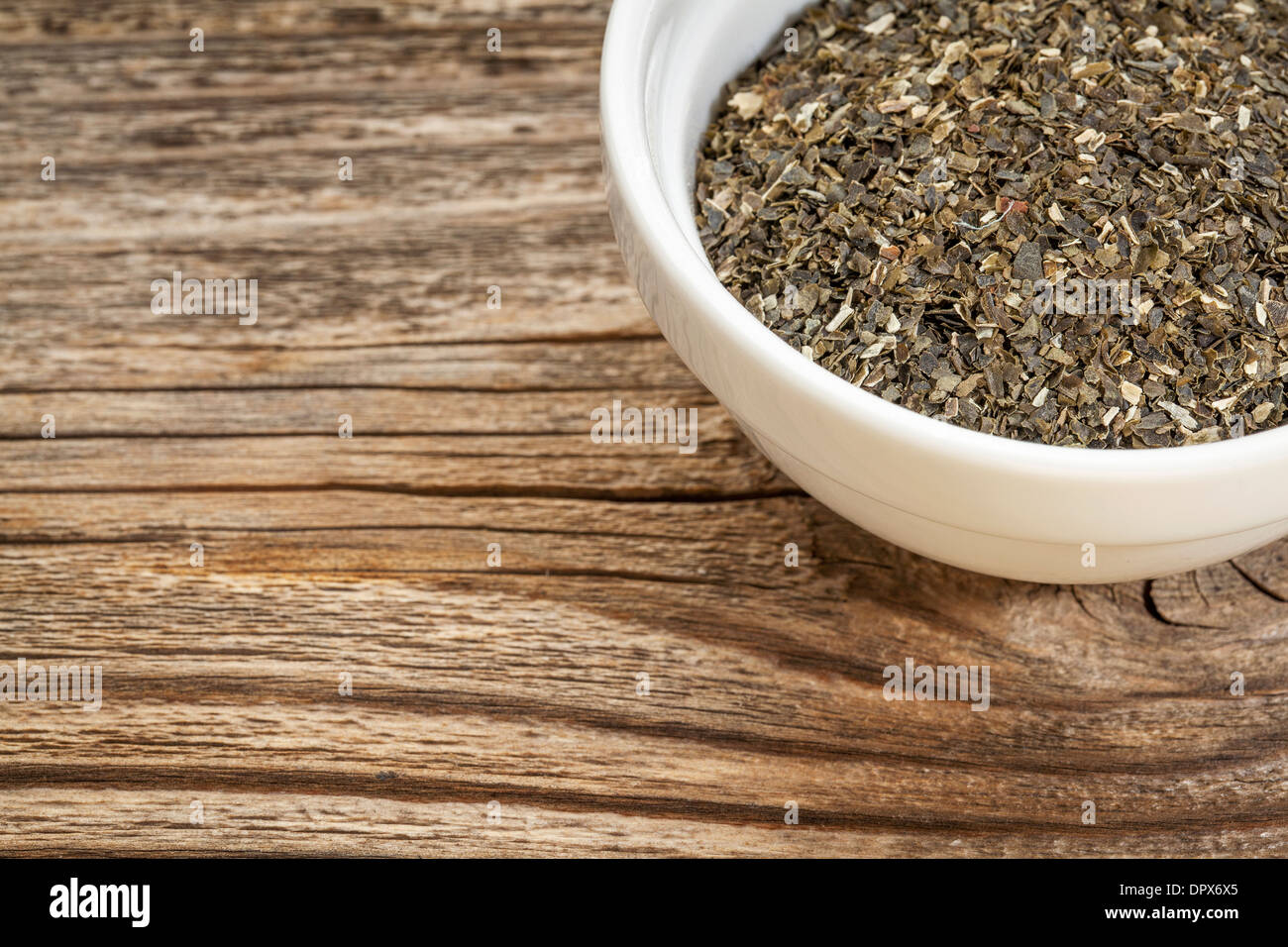 a bowl of wakame seaweed against grained wood with copy space Stock Photo