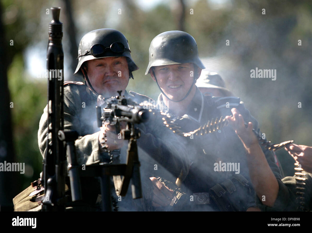 Jan 10, 2009 - Stuart, Florida, USA - Tim Brooks fires a German MG 42, while James Mislow watches to make sure the gun doesn't jam during a weapons demonstration on Jan. 10, 2009 in Stuart, FL. The demonstration was just one of the many events that was put on for the grand opening of the Road To Victory Museum in Stuart. (Credit Image: © Guy Kitchens/ZUMA Press) Stock Photo
