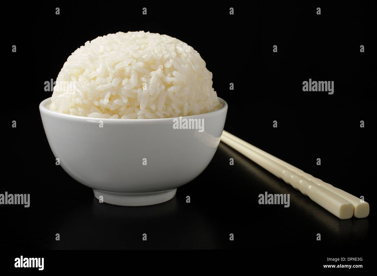 White steamed rice in ceramic bowl and chopsticks Stock Photo