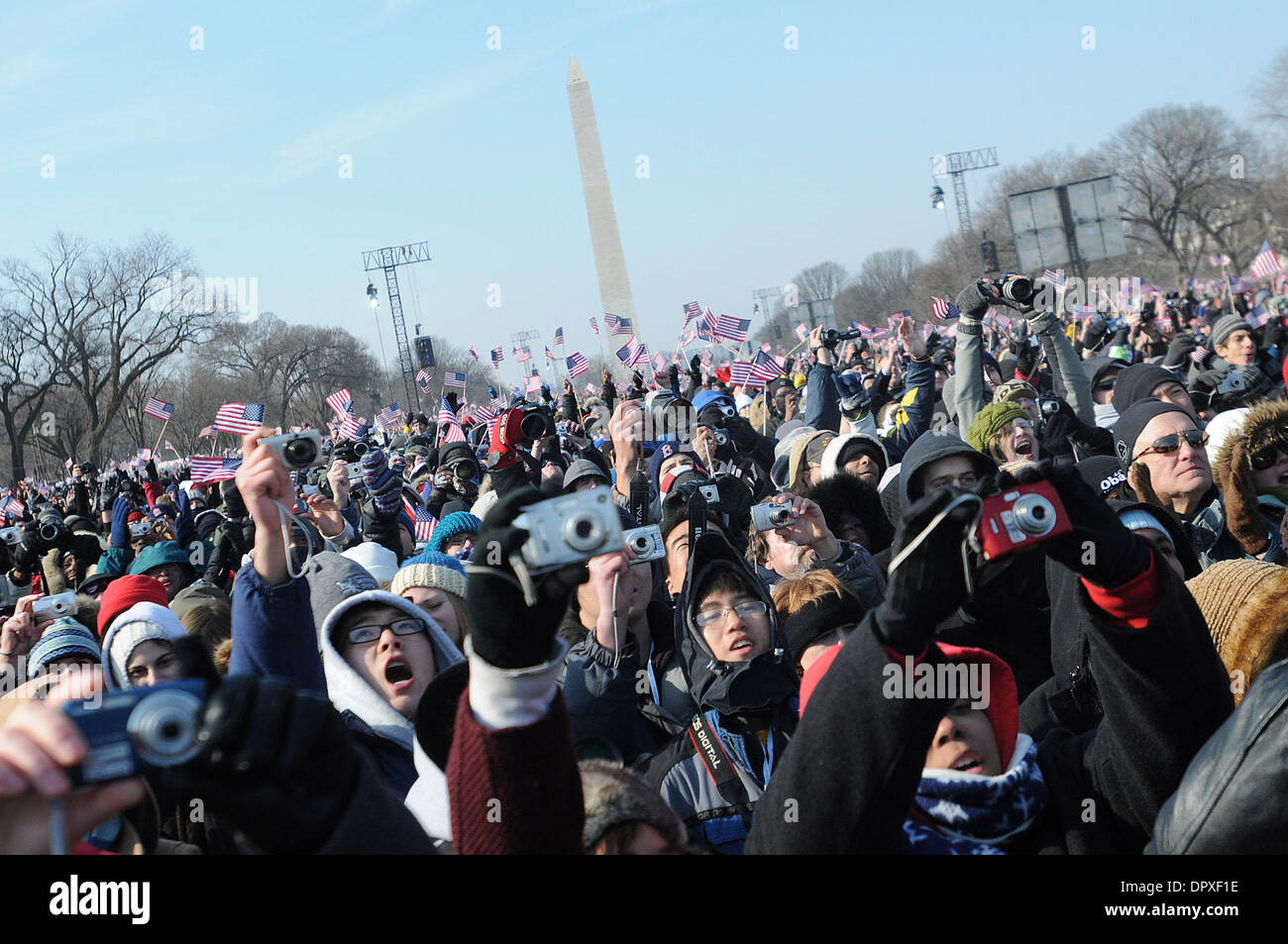 Jan 20, 2009 - Washington, District of Columbia, USA - Crowds of people gather on the National Mall while waiting for the historic inauguration of Democrat Obama as the 44th president of the United States. Washington monument behind the crowd. (Credit Image: © Laura Segall/ZUMA Press) Stock Photo
