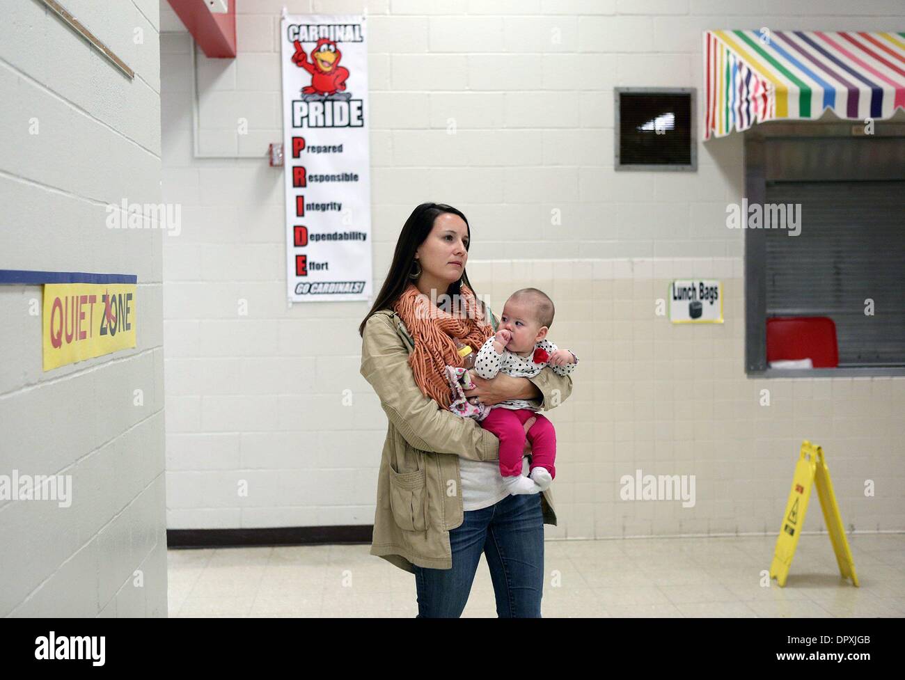 Jan. 16, 2014 - U.S. - January 16, 2014 - Emily Stiles holds her daughter  Laura Claire Stiles, 6 months, while she listens to a speaker during open  house at Germantown Elementary