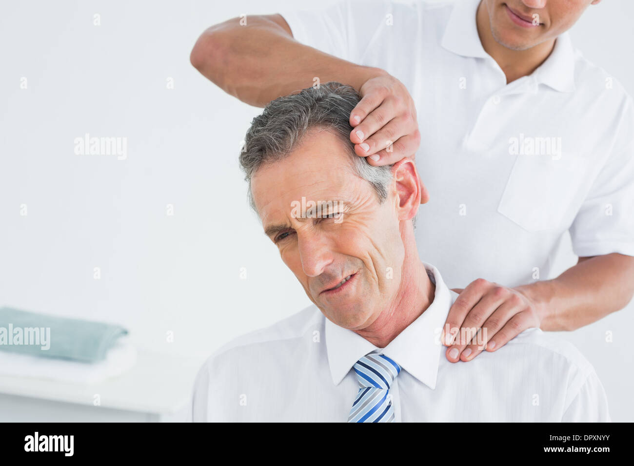 Male chiropractor doing neck adjustment Stock Photo Alamy