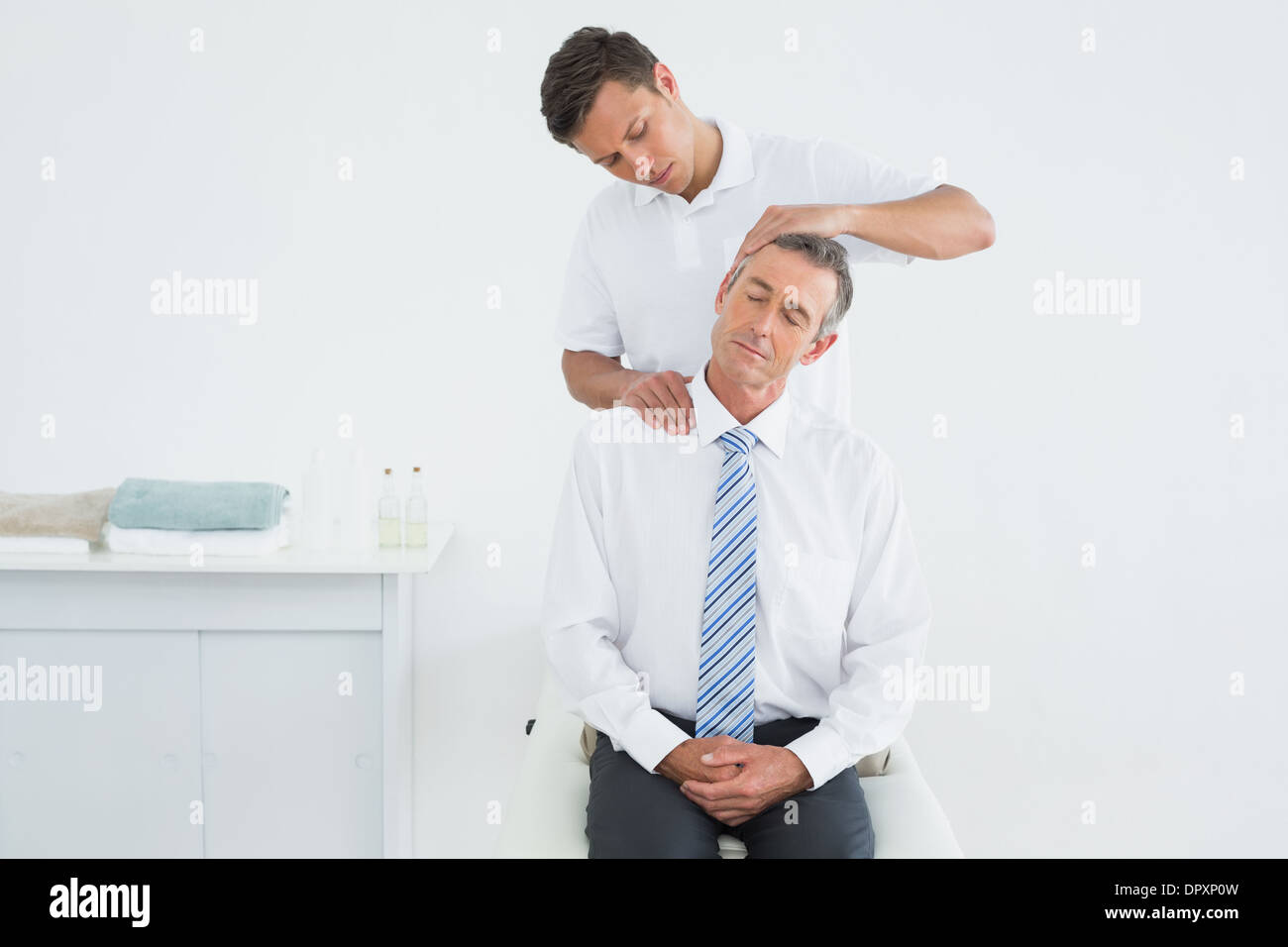 Chiropractor doing neck adjustment Stock Photo Alamy