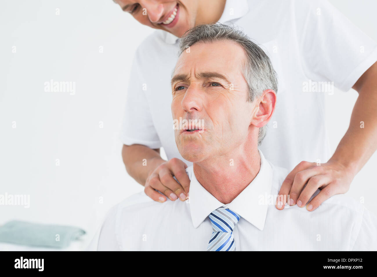 Chiropractor massaging patients neck Stock Photo - Alamy