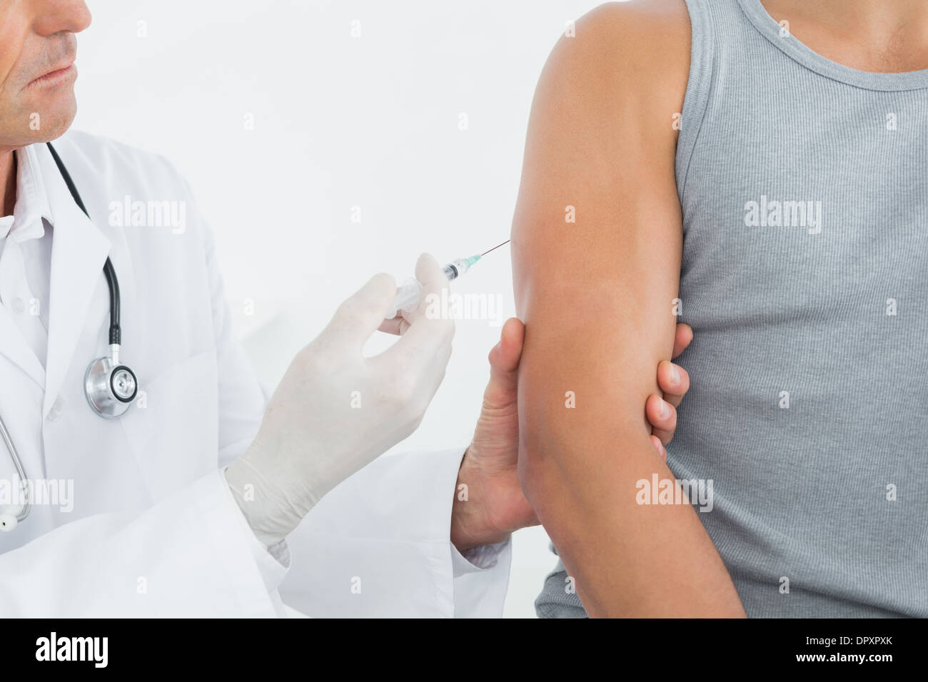 Doctor injecting patients arm hi-res stock photography and images - Alamy
