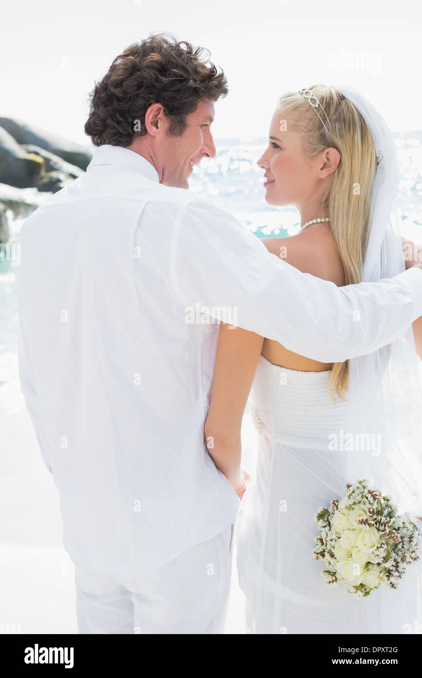 Smiling bride and groom looking at each other Stock Photo