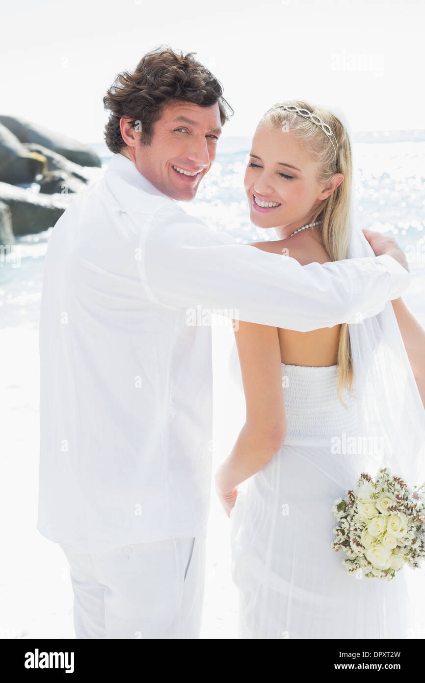 Smiling bride and groom looking at camera Stock Photo