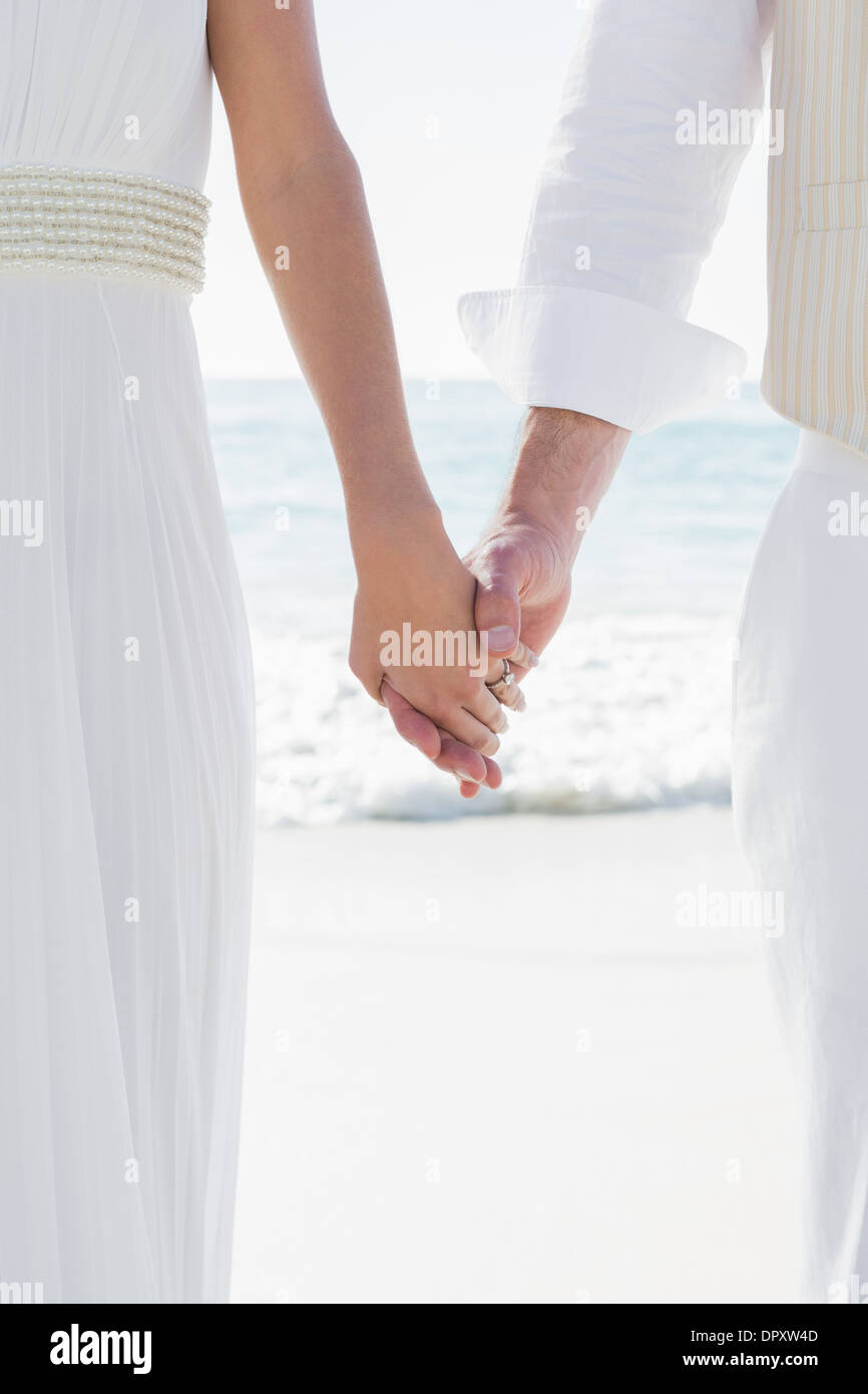 Newlyweds holding hands close up Stock Photo