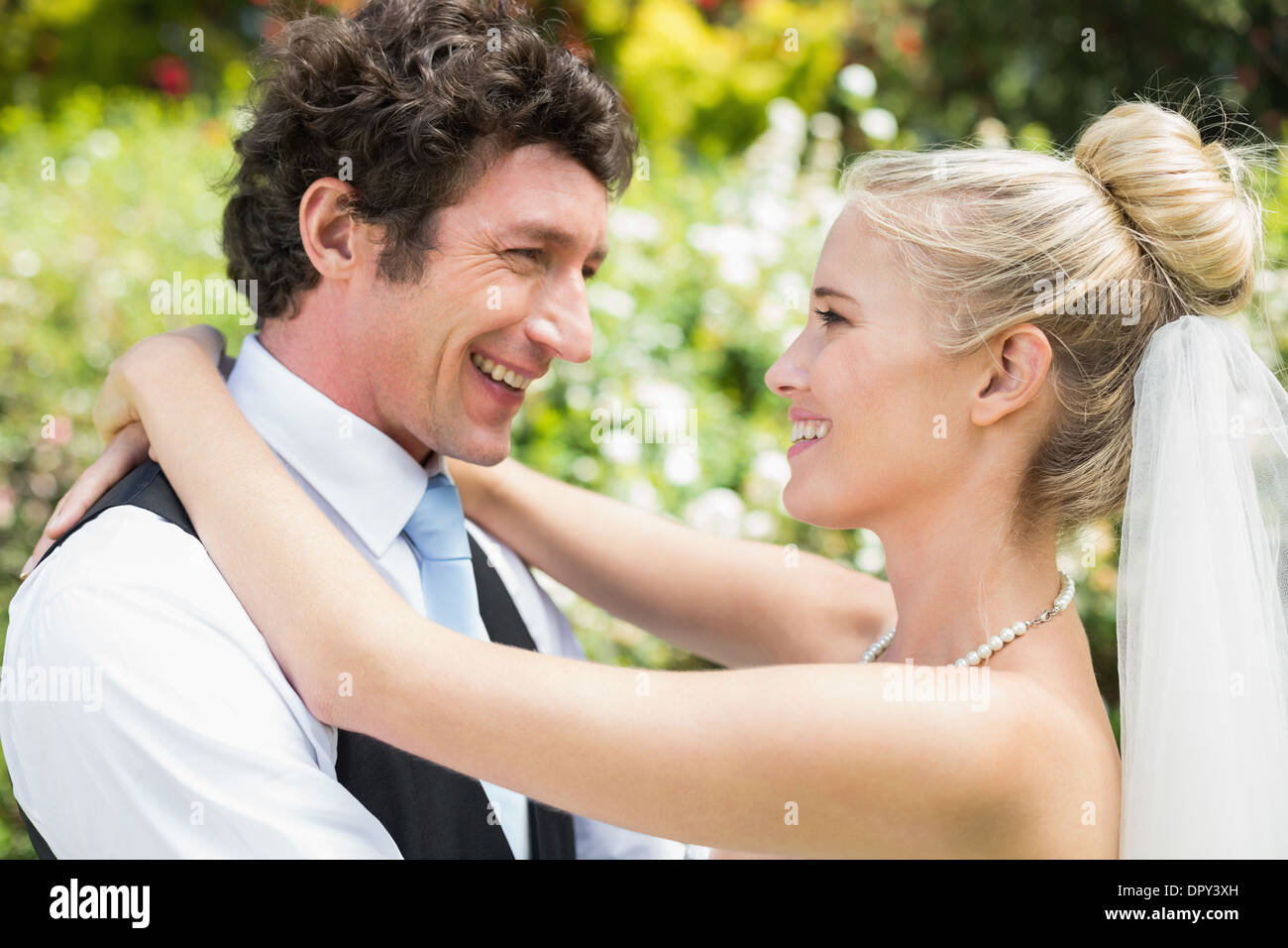 Romantic happy newlywed couple hugging each other Stock Photo - Alamy