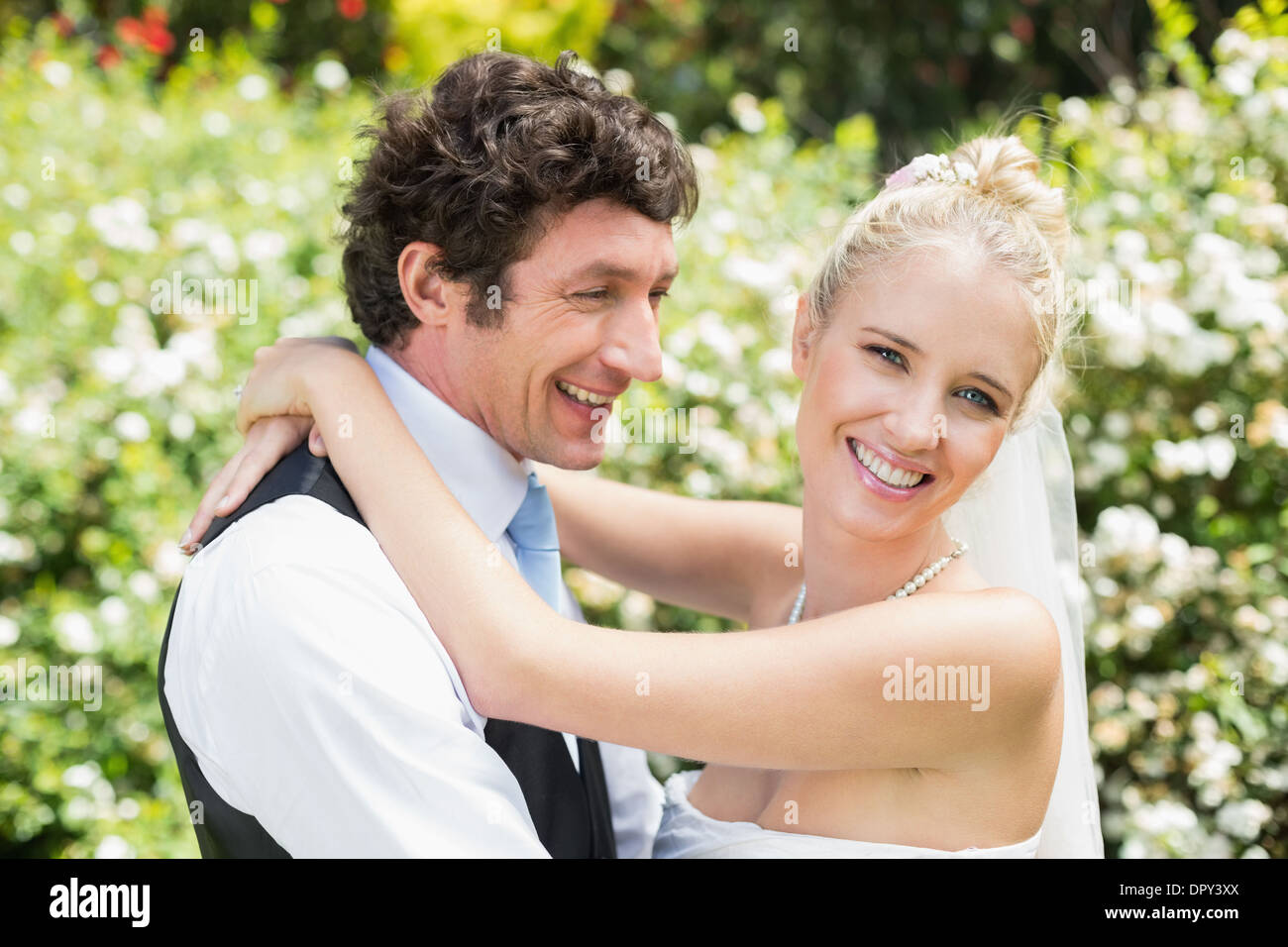Romantic smiling newlywed couple hugging each other Stock Photo - Alamy