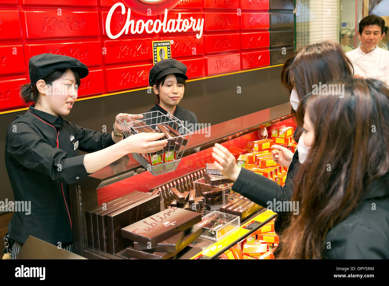Tokyo, Japan. 17th January 2014.  Customers buy the first limited edition of Kit Kat products at the "Chocolatory", the first store in the world at Seibu Ikebukuro shopping building . The "Chocolatory" is a combination of chocolatier and chocolate factory. This is the first Kit Kat Chocolatory store in the world, the first limited edition are the "Special Cherry Blossom Green Tea", "Sublime Bitter" and "Special Chili", which has a chili pepper cream. Credit:  Rodrigo Reyes Marin/AFLO/Alamy Live News Stock Photo